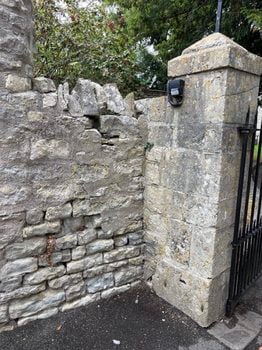 West Gate Return photo showing the section of wall to be maintained from the path to the church and churchyard