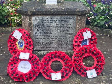 Close up image of the wreaths at Saltford War Memorial, as laid on Remembrance Sunday 2025